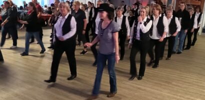 Ein Foto von der HNT Line-Dance-Party, auf dem die Teilnehmenden beim Tanzen zu sehen sind.