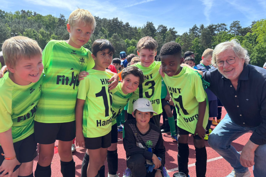 Ein Gruppenfoto von Karsten Bode und dem U9-Team der HNT nach der Pokalübergabe.